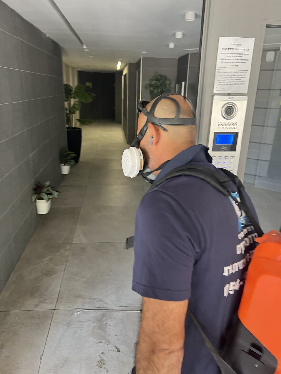 מדביר מקצועי פועל בכניסה לבניין